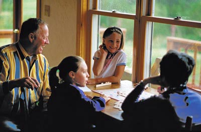 Parents and grandparents enjoy down time with the younger generation.  Cell phone, TV, and the Internet take a back seat to Scrabble!